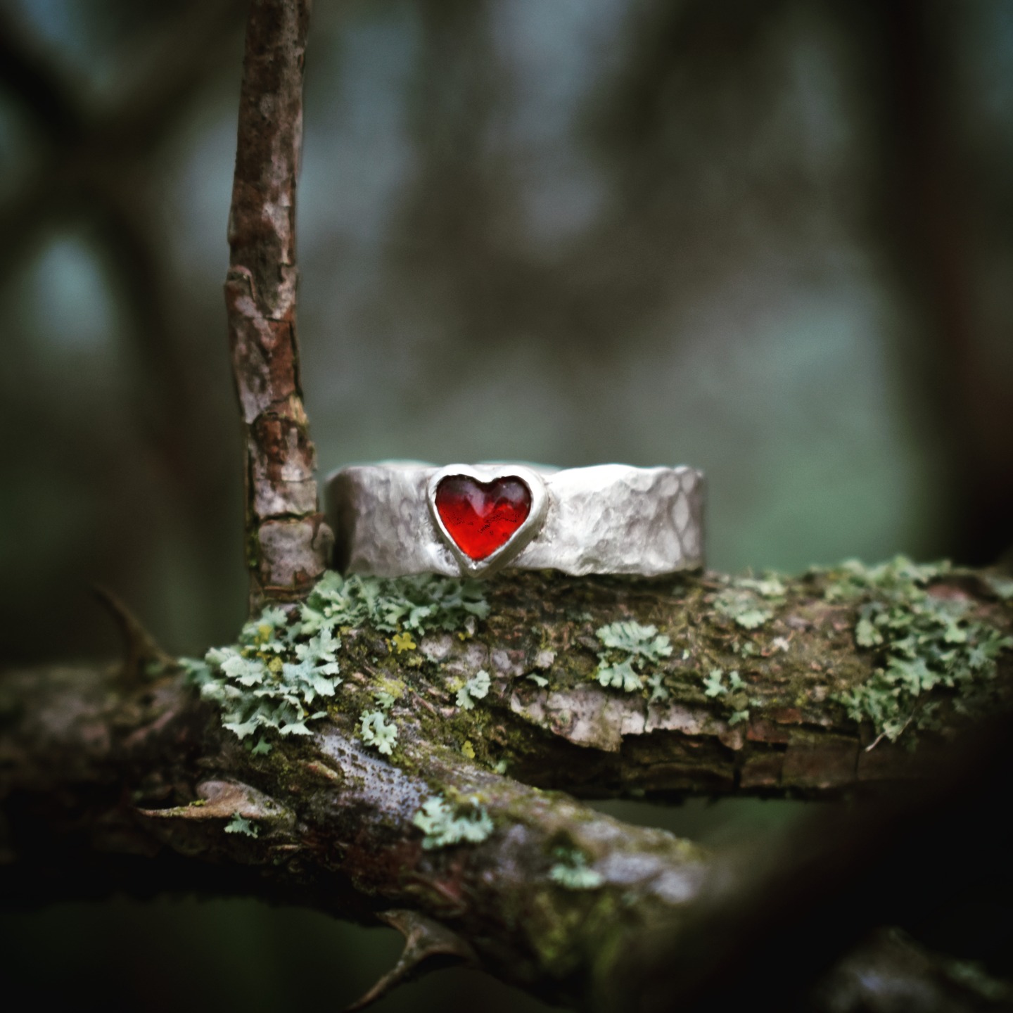 Hammered silver ring with antique glass heart