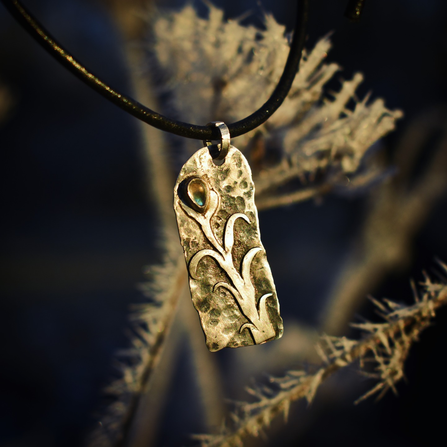 Hammered silver pendant with plant motif and moonstone